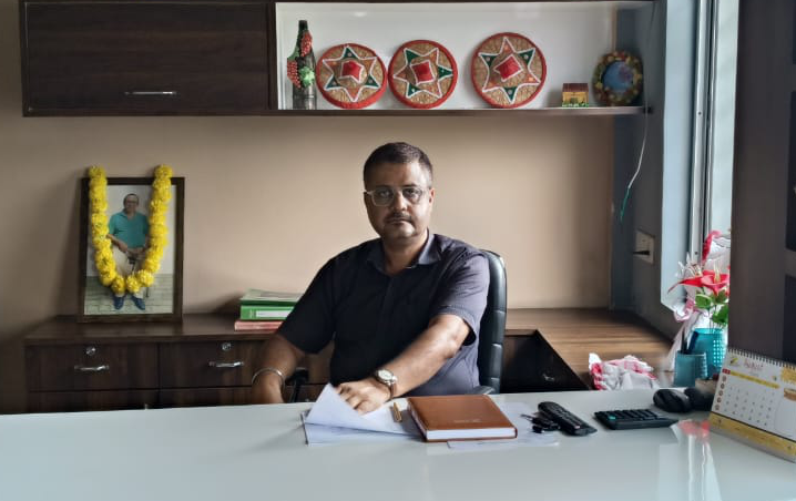 Principal Mr. Pulok Banerjee at his desk
